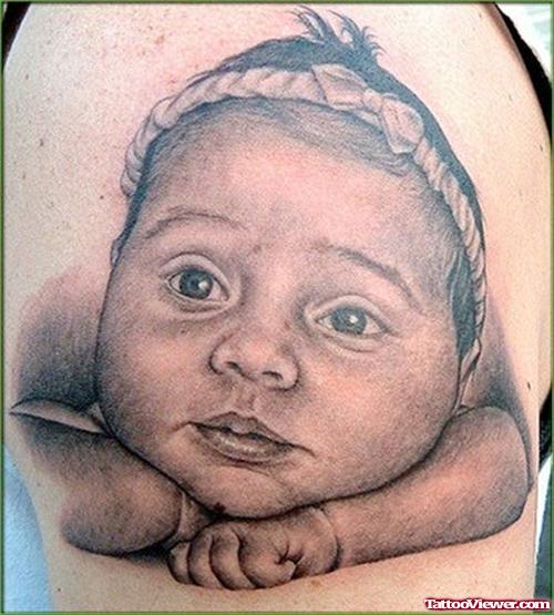 Baby Face Tattoo On Biceps
