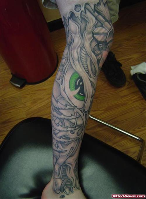 Biomechanical Green Eye Tattoo On Leg
