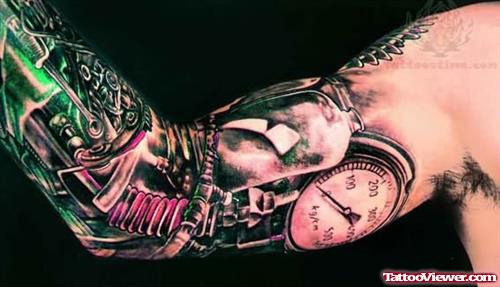 Biomechanical And Clock Tattoo On Arm