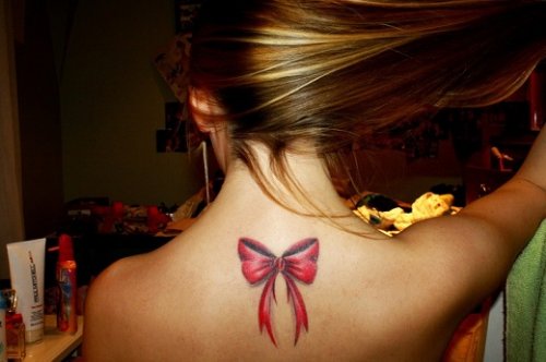 Red Bow Tattoo On Girl Upper Back
