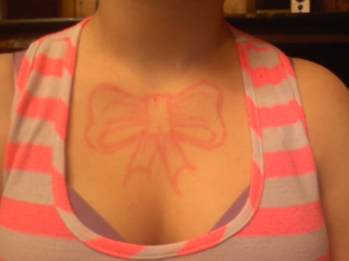 Pink Bow Tattoo On Girl Chest