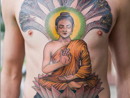 Lotus Flower And Buddhist Tattoo On Man Chest