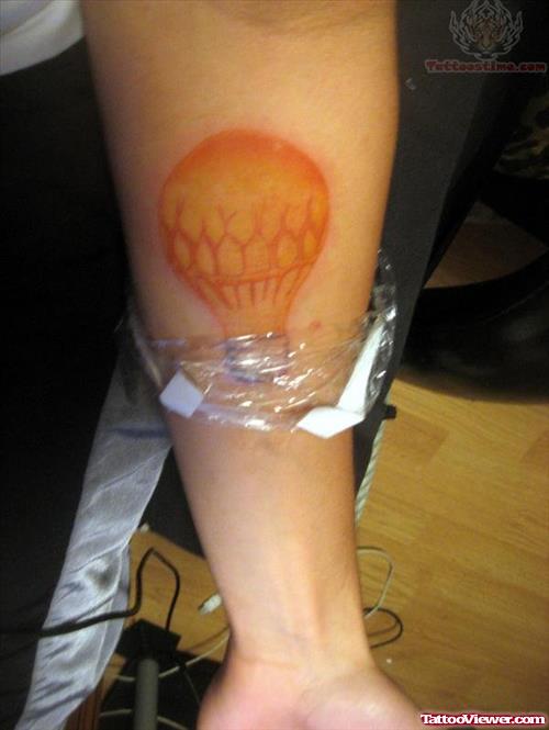 Yellow Ink Bulb Tattoo On Arm