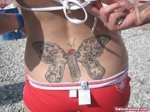 Grey Ink Butterfly Tattoo On Girl Lowerback