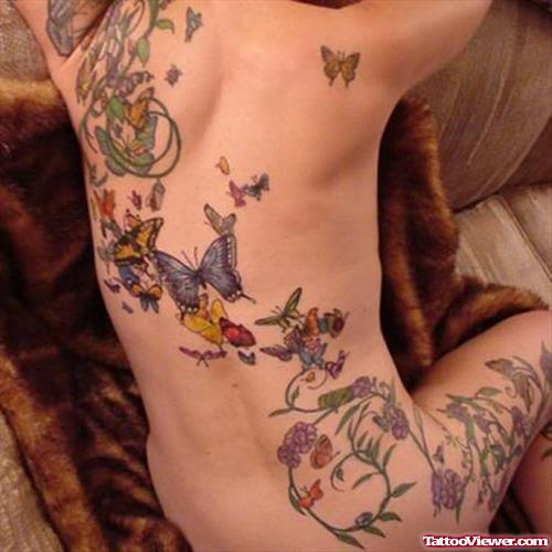 Colored Flowers And Butterflies Tattoo On Back
