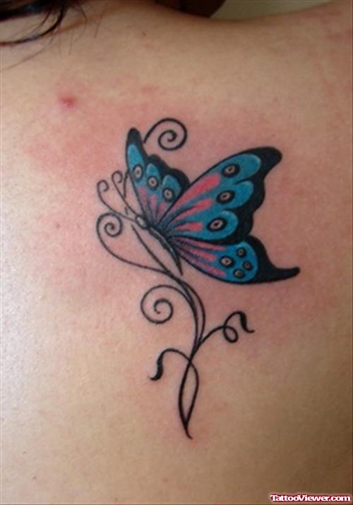 Red And Blue Ink Butterfly Tattoo On Upperback