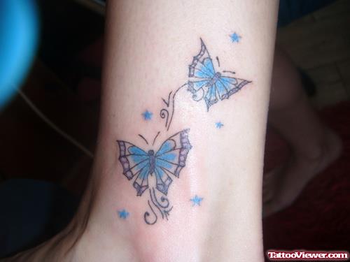 Blue Ink Butterfly Tattoo On Ankle