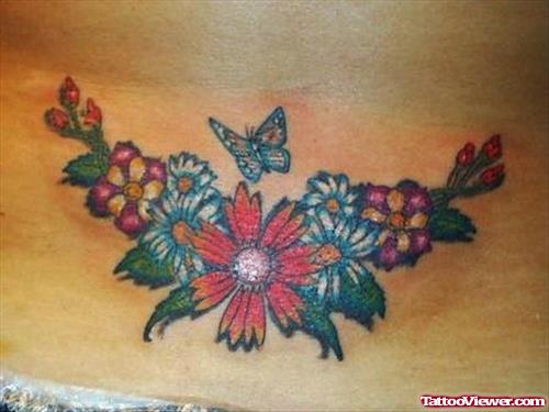 Colored Flowers And Flying Butterfly Tattoo On Lowerback