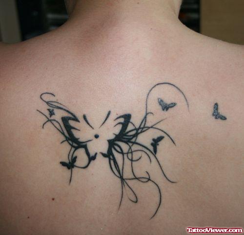 Awesome Black Ink Butterfly Tattoo On Upperback