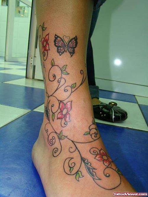 Colored Flowers And Butterfly Tattoo On Right Leg