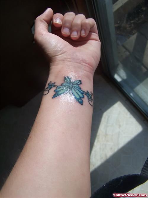 Blue Ink Butterfly Tattoo On Left Wrist