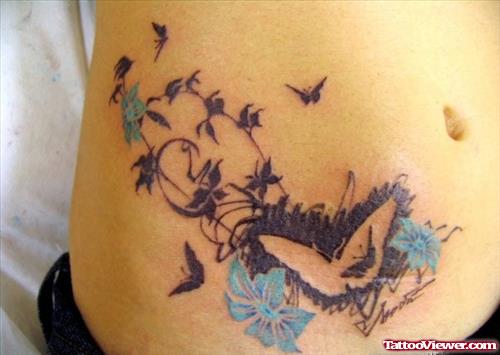 Blue Flowers And Butterfly Tattoos On Hip
