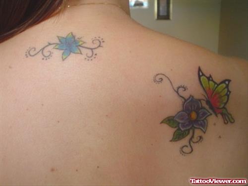 Flowers And Colored Butterflies Tattoo On Back