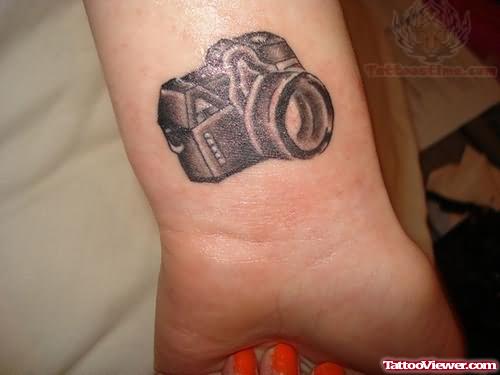Black Ink Camera Tattoo On Wrist