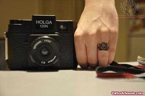 Small Camera Tattoo On Finger