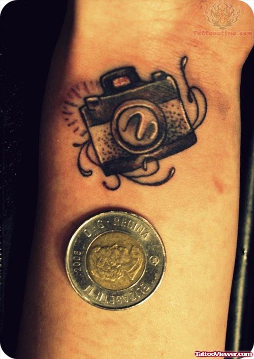 Camera Tattoo On Wrist And Coin