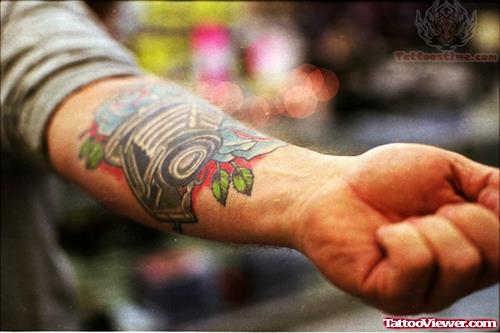 Camera And Flower Tattoo On Arm Wrist
