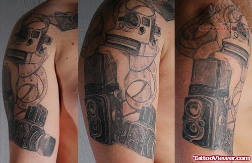 Camera And Film Roll Tattoo On Shoulder