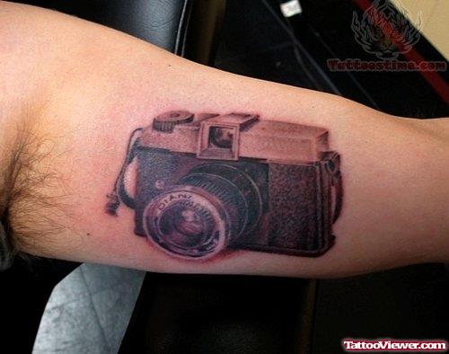 Large Camera Tattoo On Muscle
