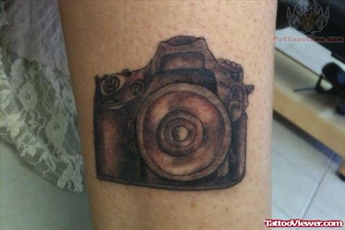 Small Camera Tattoo On Leg