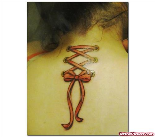 Corset And Ribbon Breast Cancer Tattoo On Upperback