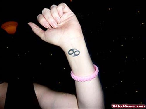 Cancer Tattoo On Girl Left Wrist
