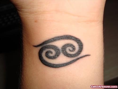 Black Ink Cancer Tattoo On Left Wrist