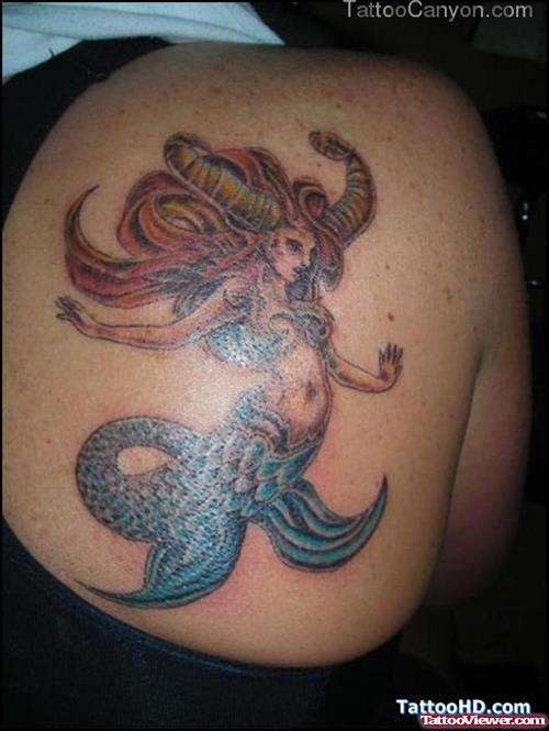 Colored Capricorn Tattoo On Back Shoulder For Girls