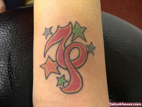 Colored Stars And Red Ink Capricorn Tattoo