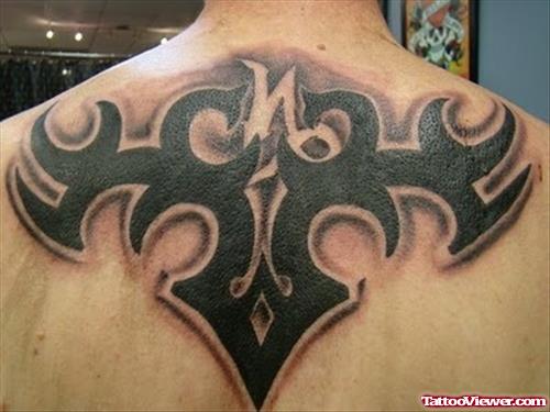 Black Ink Tribal Capricorn Tattoo On Upperback