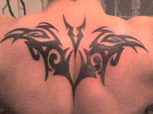 Tribal And Capricorn Tattoo On Upperback