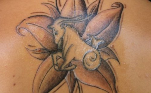 Grey Ink Flower And Capricorn Tattoo