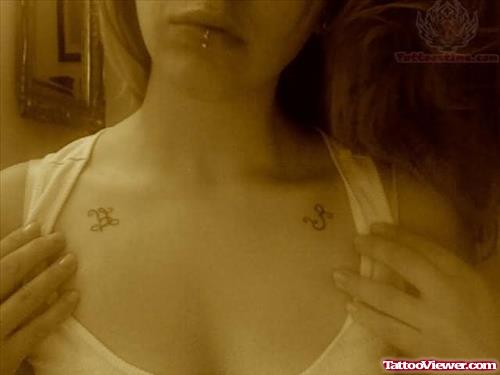 Lip Piercing And Om Design Tattoo On Chest