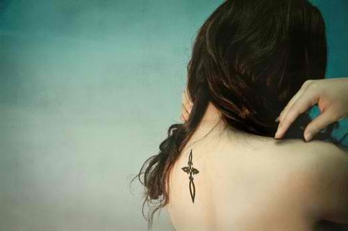 Girl With Christian Cross Tattoo On Back