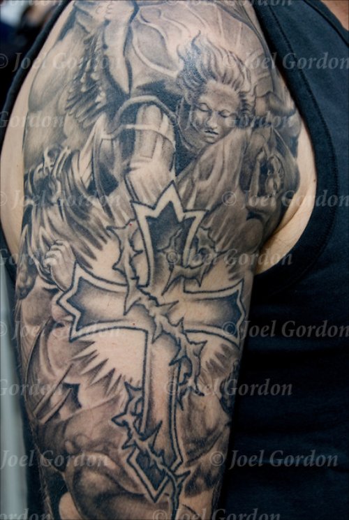 Grey Ink Cross Christian Tattoo On Man Right Sleeve