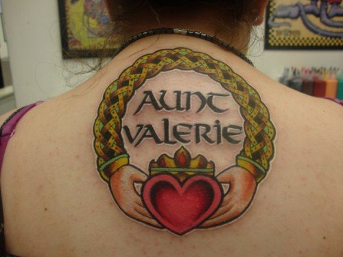 Cool Claddagh Tattoo On Girl Upper Back