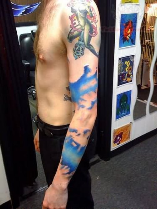 Blue Ink Cloud Tattoo On Left Sleeve