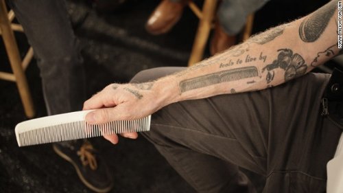 Tools To Live By – Grey Ink Comb Tattoo On Right Arm