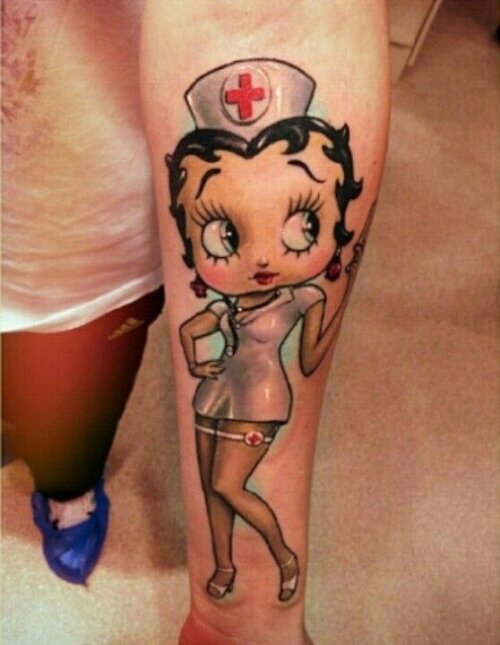 Betty Boop In Nurse Costume Tattoo On Forearm
