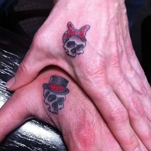 Grey Ink Male And Female Skull Couple Tattoo