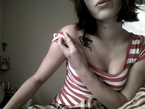 Girl SHowing Her Crane Tattoo