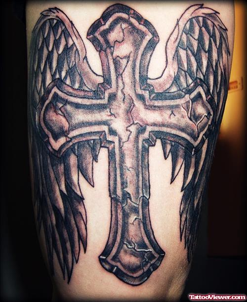 Grey Ink Wined Cross Tattoo On Thigh