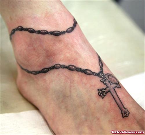 Grey Ink Rosary Cross Tattoo On Right Ankle