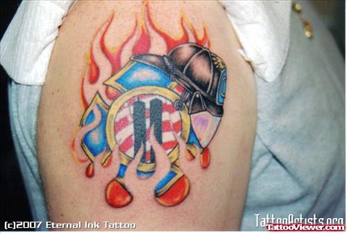 Flaming Cross With Cap Color Ink Tattoo On Shoulder