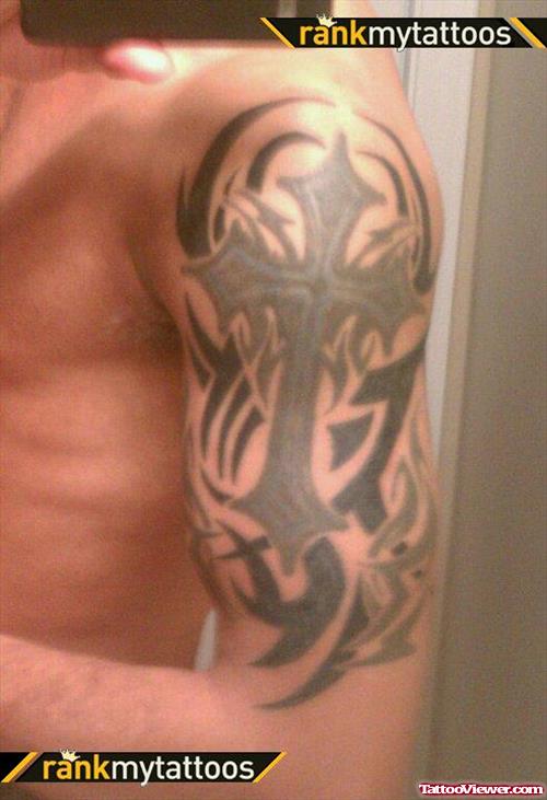 Cross And Tribal Tattoo On Man Left Half Sleeve