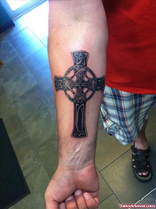 Black Ink Cross Tattoo On Right Arm