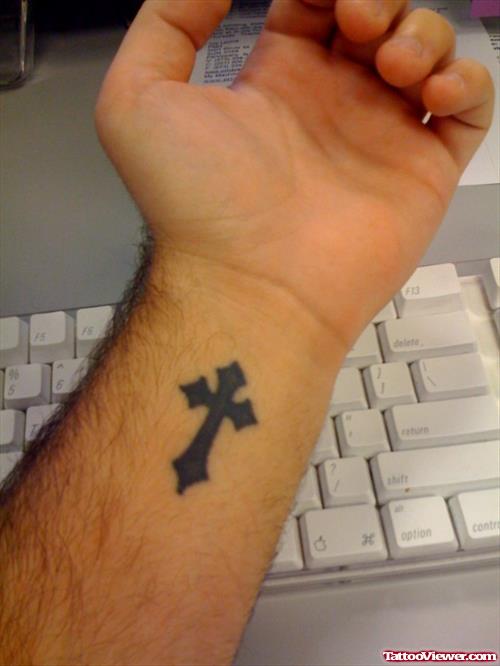 Black Ink Cross Tattoo On Left Wrist