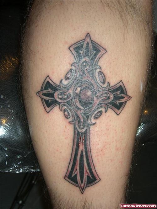 Black Ink Cross Tattoo On Back Leg