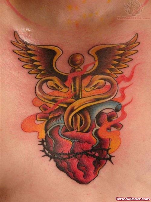 Winged Cross With Human Heart Tattoo On Chest