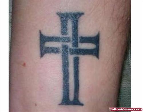 Black Ink Cross Tattoo On Bicep